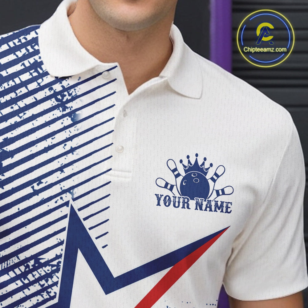 A close-up of a white short-sleeve polo shirt with a blue bowling-themed graphic on the chest, including a crown, bowling pins, and the text 'YOUR NAME'. The left side of the shirt has a blue diagonal striped pattern.