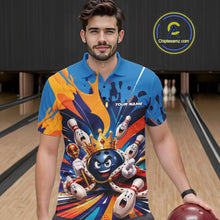 Load image into Gallery viewer, Front view of a male model wearing a bowling polo shirt showcasing a crowned cartoon bowling ball with a royal scepter, animated bowling pins, and colorful paint splash artwork in a bowling lane.