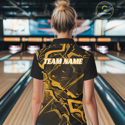 Back view of a womens black and yellow bowling quarter-zip showcasing a cracked geometric pattern and angular lines.
