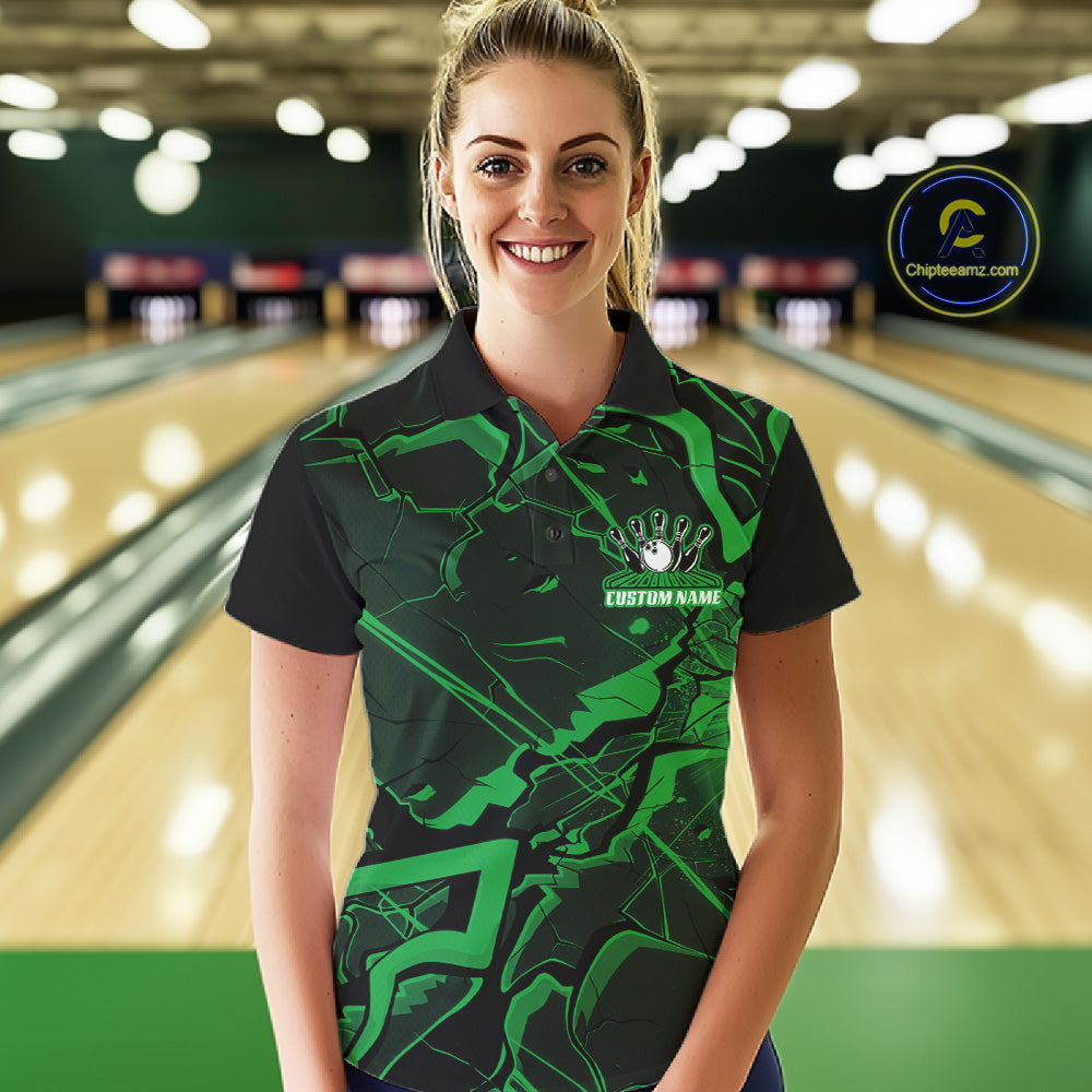 Female model wearing a black and green bowling polo in a bowling lane with cracked geometric artwork.