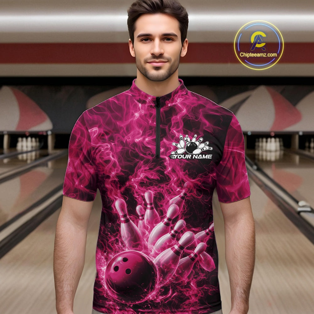 Male model wearing a bowling quarter-zip in a bowling lane with a pink bowling ball striking pins and fiery graphics.