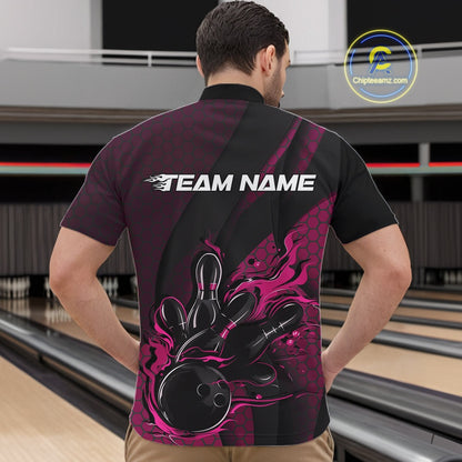 Front view of a male model in a bowling venue wearing a black and pink quarter-zip shirt featuring a flaming bowling ball hitting the pins.