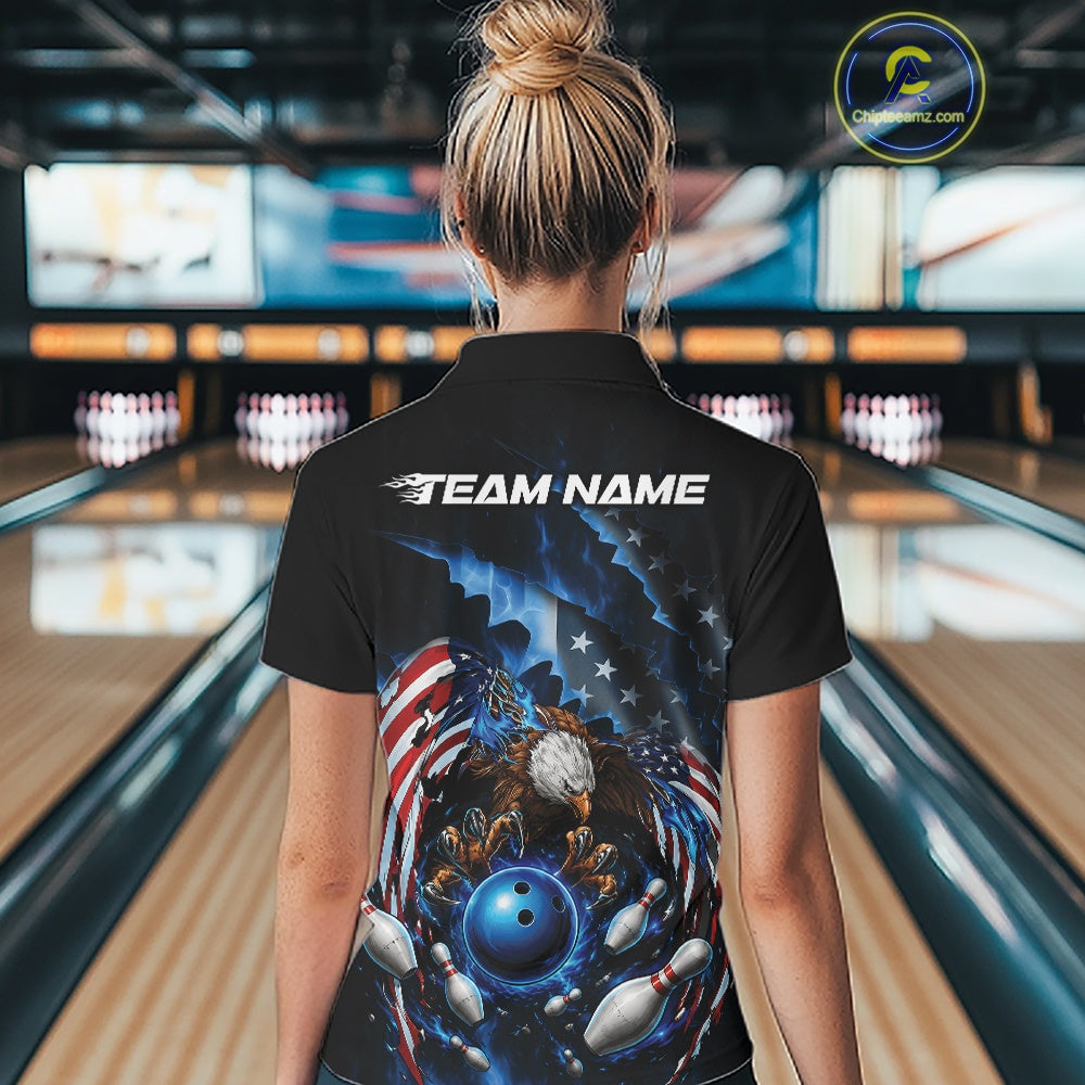 Back view female model at the bowling lane wearing a quarter zip shirt with bald eagle gripping a blue bowling ball, flying pins, and American flag background.
