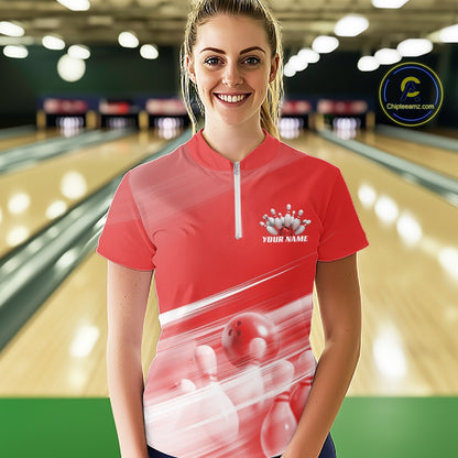 Front view female model in a bowling lane wearing a red quarter zip shirt with bowling ball and pins geometric artwork.