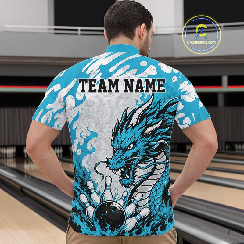 Man wearing a blue bowling shirt with a dragon design and 'TEAM NAME' text in a bowling alley.