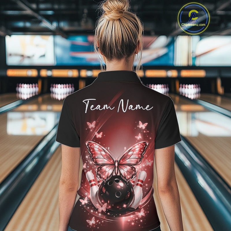 Back view of a female model in a bowling center wearing a red quarter-zip bowling shirt showcasing glowing butterflies and fallen pin artwork.