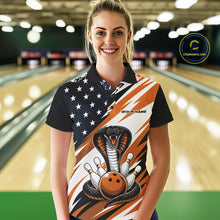Load image into Gallery viewer, A woman stands in a bowling alley wearing a black, white, and orange bowling shirt with stars, diagonal stripes, a cobra, pins, and an orange ball.