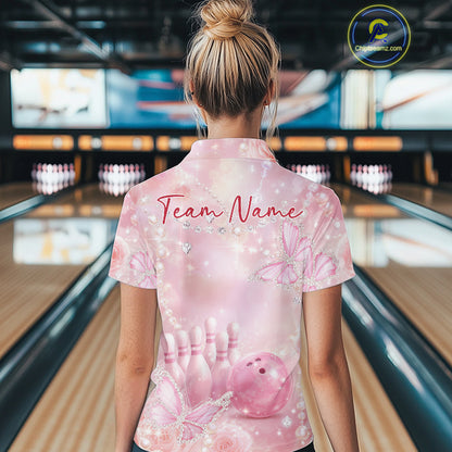 Back view of a female model at a bowling lane wearing a quarter-zip bowling shirt decorated with glitter butterflies, roses, and bowling-themed graphics.