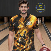 Load image into Gallery viewer, Front view of a male model wearing a bowling polo shirt showcasing a black and gold bowling ball hitting the pins graphic with flowing metallic ribbon accents in a bowling lane.