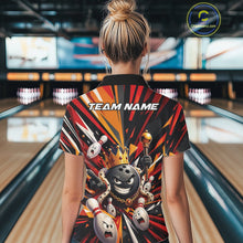 Load image into Gallery viewer, Back view of a female model wearing a black, red, and orange bowling polo shirt showcasing a crowned cartoon bowling ball holding a royal scepter with animated bowling pins and colorful burst artwork in a bowling lane.