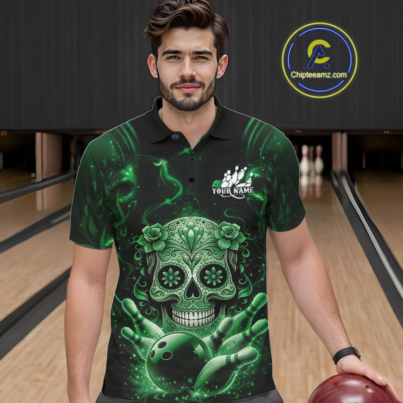Male model wearing a black and green bowling polo shirt at a bowling lane with sugar skull and bowling strike graphics.