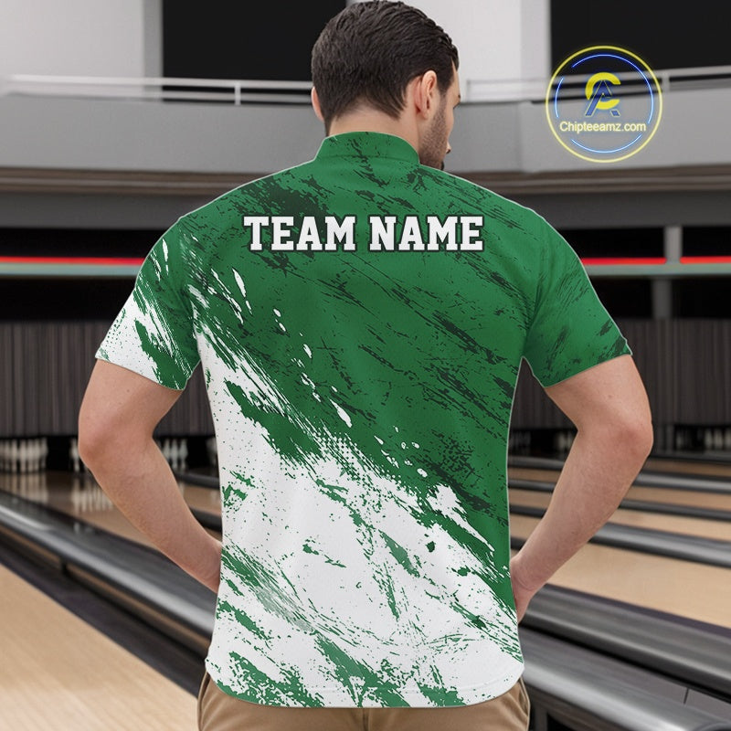 Man wearing a green and white sports jersey with 'TEAM NAME' printed on the back, standing in a bowling alley.