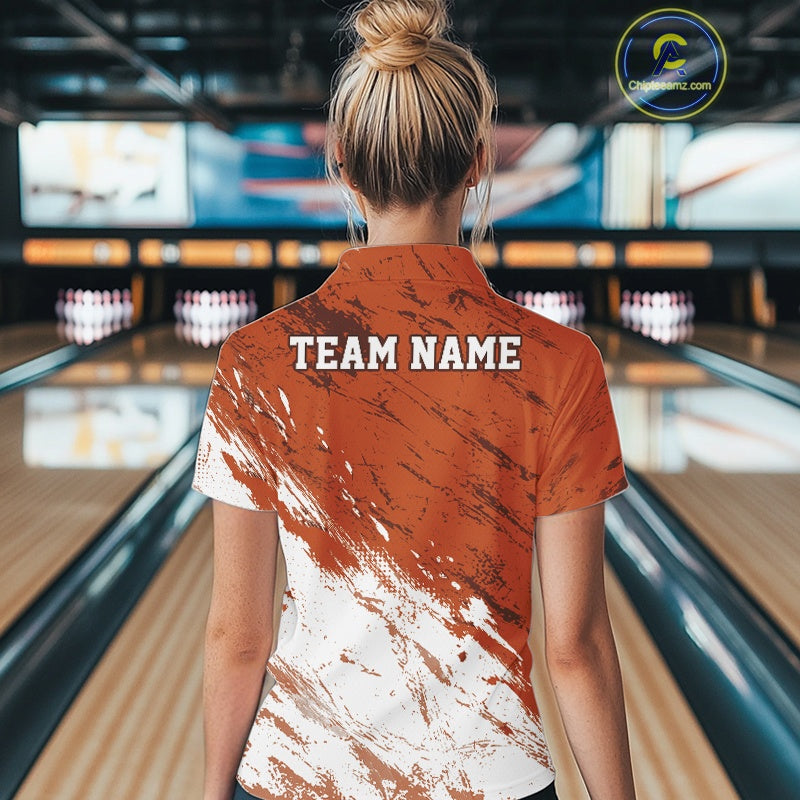 Person wearing a bowling shirt with 'TEAM NAME' on the back in a bowling alley.