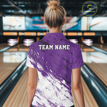 Load image into Gallery viewer, Back view of a female model in a bowling alley wearing a bowling polo shirt featuring a white and purple paint splatter distressed sportswear design.
