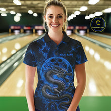 Load image into Gallery viewer, Front view of a female model in a bowling alley wearing a blue custom bowling polo shirt featuring an ancient dragon, flames, and a moon-inspired bowling ball design.