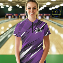 Load image into Gallery viewer, Woman wearing a purple bowling shirt with a logo and text in a bowling alley.