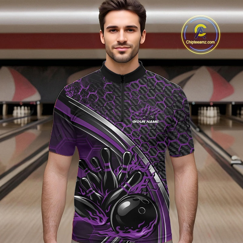 Male model in a bowling lane wearing a black and purple quarter zip shirt with honeycomb accents and a fiery bowling strike illustration.