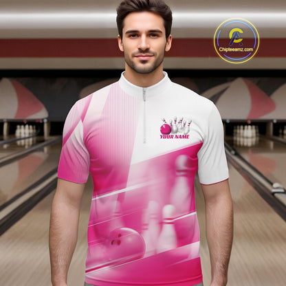 Male model front view at the bowling lane wearing a white and pink bowling quarter zip shirt with bowling ball and pins pattern.