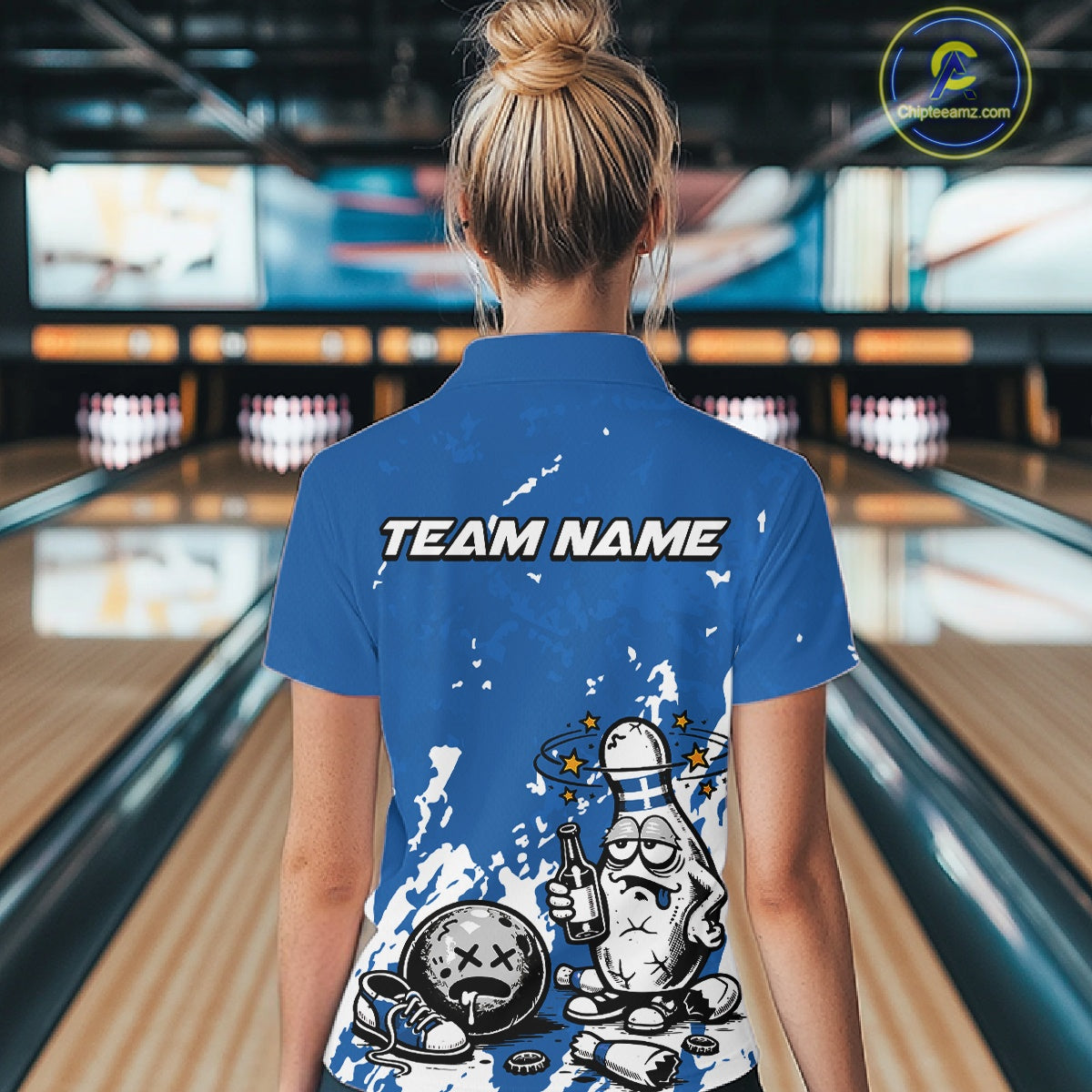 Back view of a female bowler wearing a blue and white polo shirt, grunge splatter-style drunk bowling pin illustration holding beer and bowling ball.