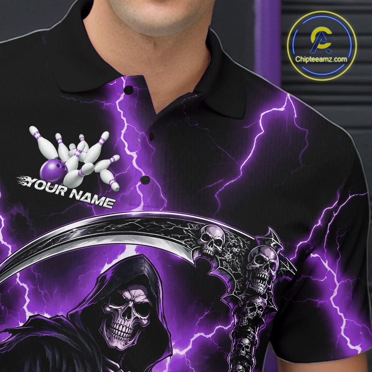A close-up of a person wearing a black polo shirt with a vivid purple lightning design, a grim reaper skull graphic, bowling pins, and the text 'YOUR NAME' on the chest. 