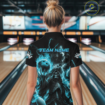 A woman viewed from behind wearing a black short-sleeve bowling shirt with a vivid blue and black lightning-themed graphic and the text 'TEAM NAME' across the back, standing in a bowling alley.