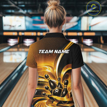Load image into Gallery viewer, Back view of a female model wearing a bowling quarter zip shirt with glossy gold and black bowling ball and pins artwork in a bowling lane.