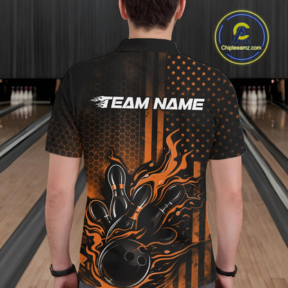 Back view of a male model in a bowling alley wearing a black and orange polo featuring a flaming bowling ball and pins design.
