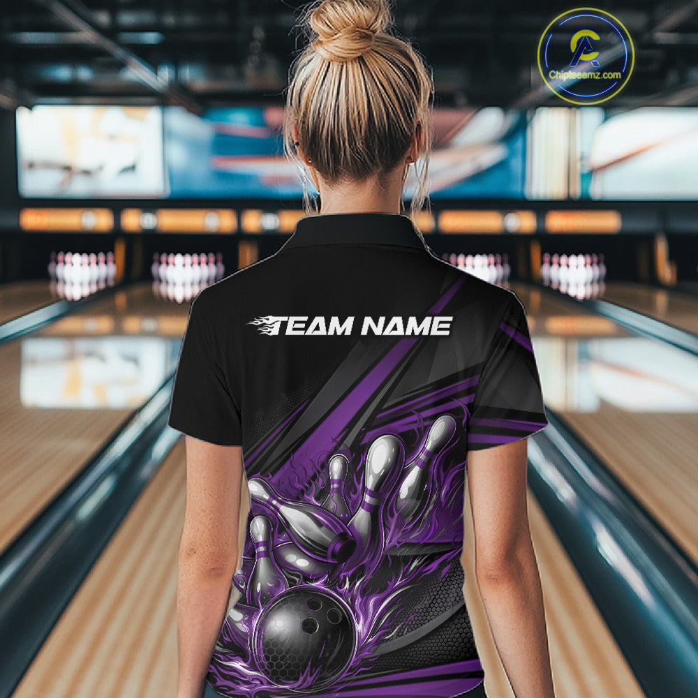 Back view of a female bowler wearing a black quarter-zip shirt, purple flame bowling strike artwork with geometric stripe design.