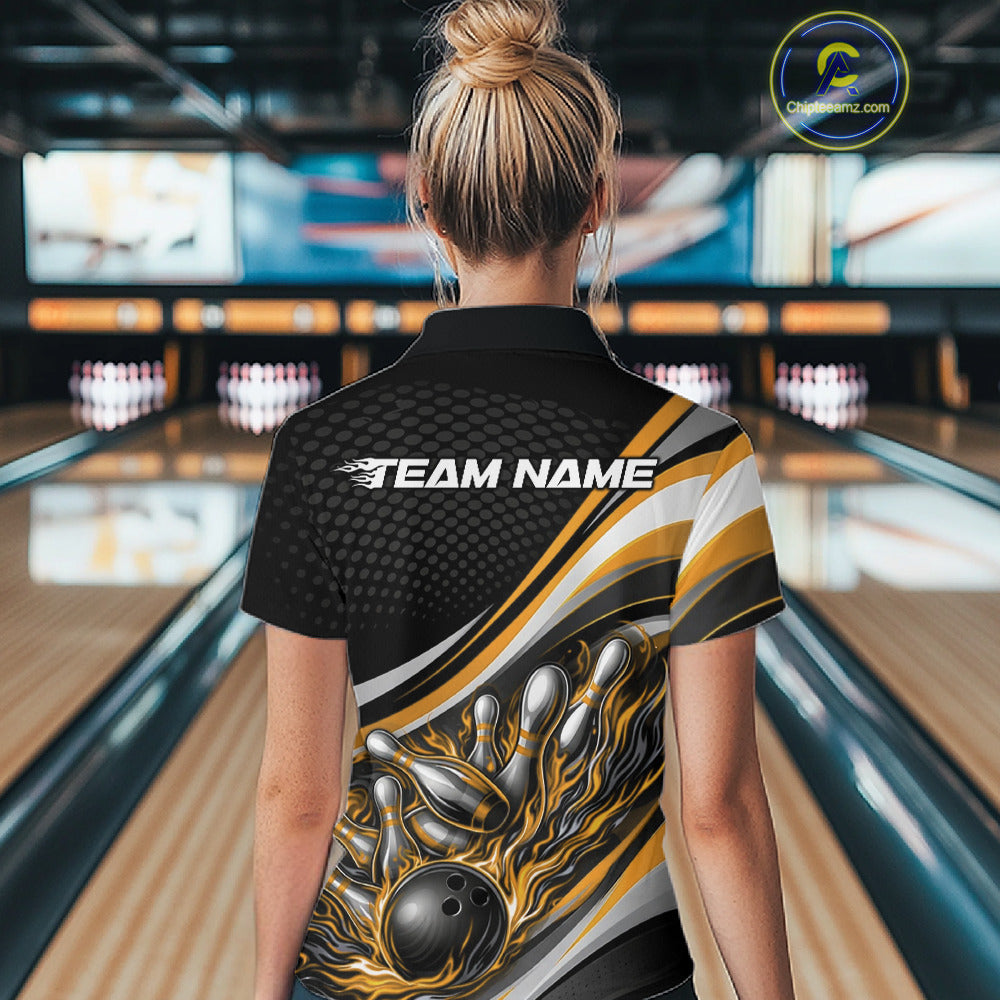 Back view female model in black and yellow quarter zip bowling shirt in bowling lane, flame bowling ball and pins sports graphic