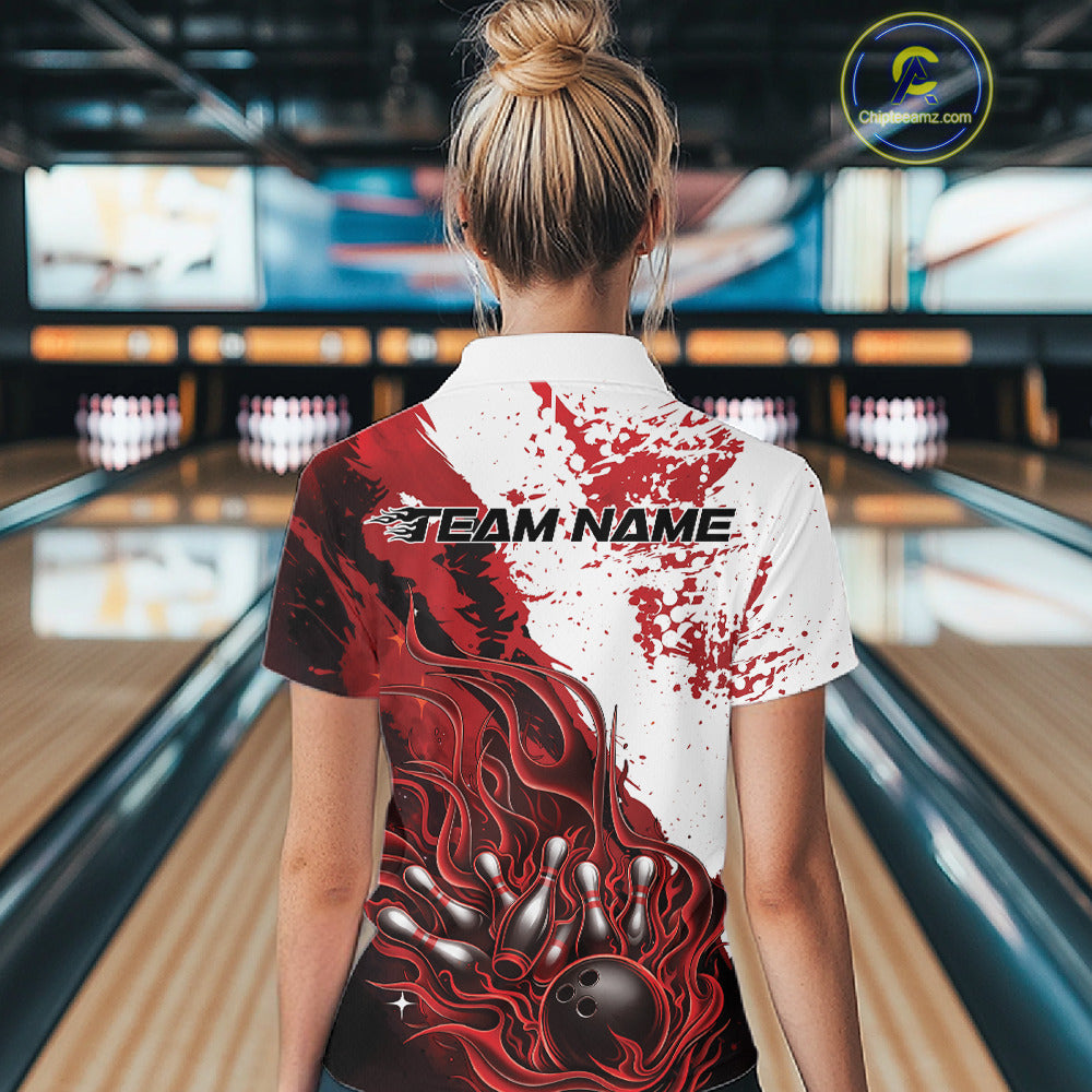 Back view of a female model in a bowling lane wearing a black quarter-zip shirt featuring red and white flame bowling ball and pins design with bold sports styling.