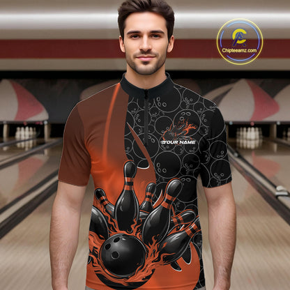 Male model front view at bowling lane wearing black and orange quarter zip shirt with flaming bowling ball design and energetic bowling strike graphics