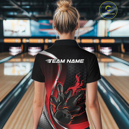 Back view female model inside bowling center wearing black and red quarter zip shirt featuring flame bowling ball hitting pins design
