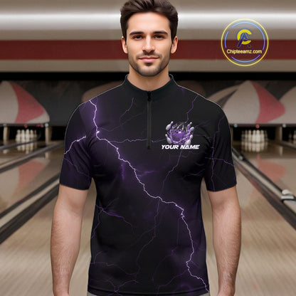 Male model wearing a black and purple quarter-zip in a bowling alley with dragon claw artwork and fiery bowling graphics.