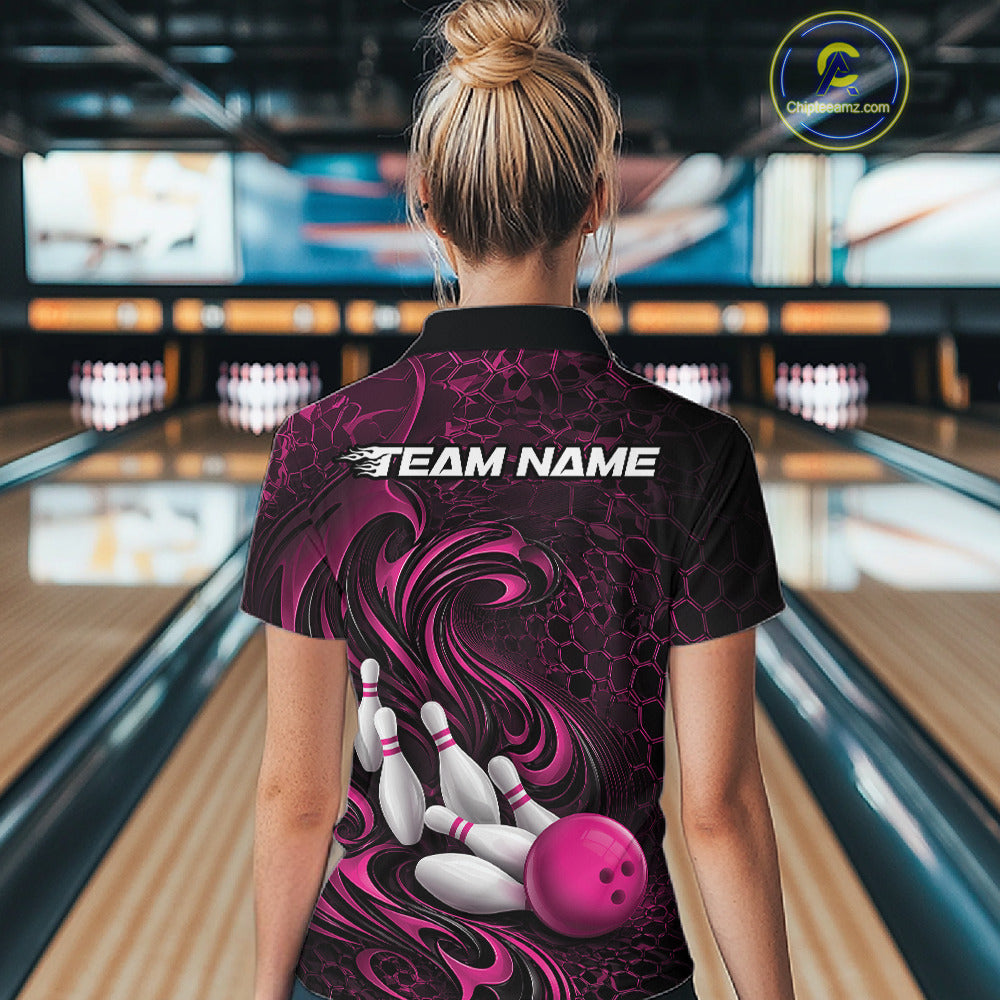 Back view of a female model wearing a black and pink bowling quarter-zip shirt in a bowling alley featuring a tribal flame bowling ball and pins graphic