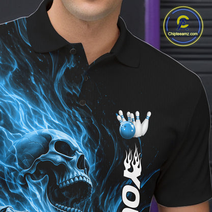 Close-up of the left chest on a black bowling polo shirt featuring a skull clutching a bowling ball surrounded by swirling blue energy flames