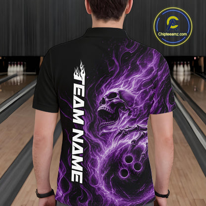 Back view of a male bowler in a bowling alley wearing a black bowling polo shirt featuring a purple energy-flame skull clutching a bowling ball