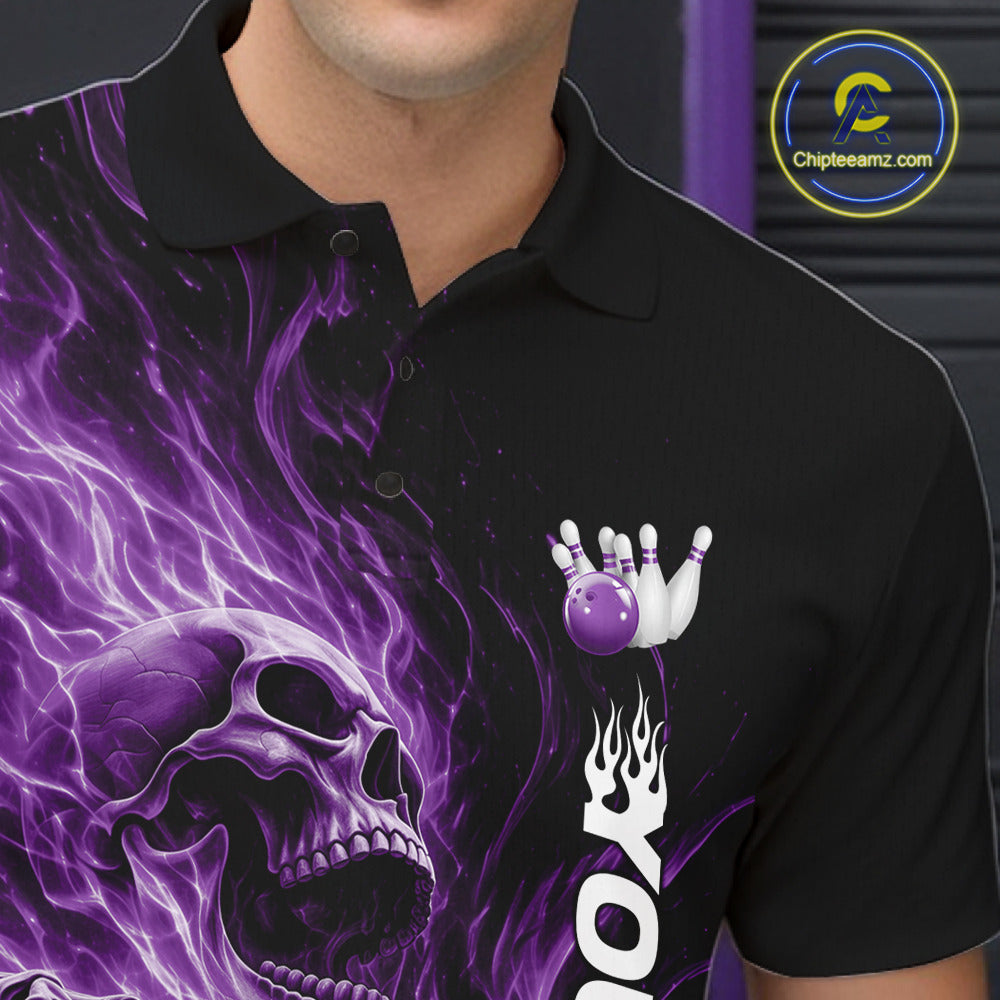 Close-up of the left chest on a black bowling polo shirt featuring a skull clutching a bowling ball surrounded by swirling purple energy flames