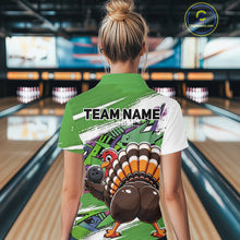 Load image into Gallery viewer, Back view of a female model wearing a green custom bowling polo shirt with a funny graffiti turkey holding a bowling ball, paint splatter accents, and a personalized name in a bowling alley.
