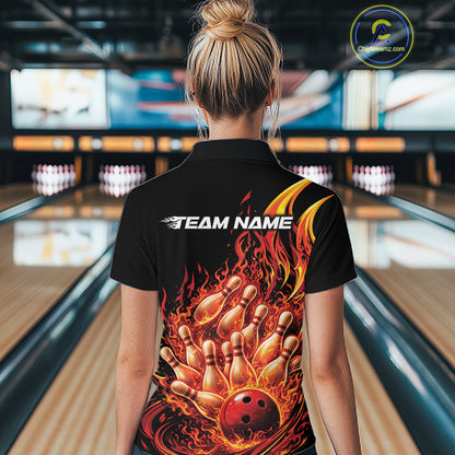 Back view female model in bowling lane wearing black and red quarter zip featuring flaming bowling ball striking pins with vivid fiery action graphics.
