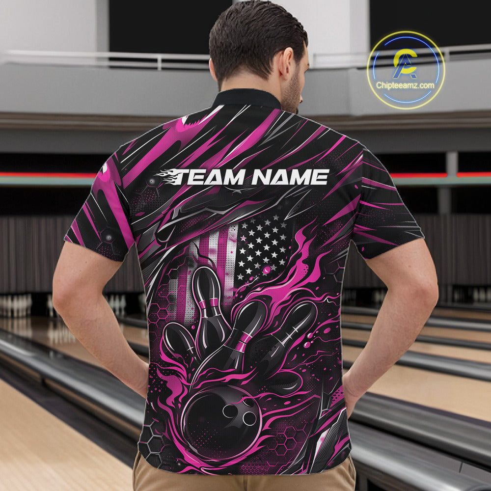 Front view of a male model in a bowling alley wearing a black and pink quarter-zip shirt featuring a flaming bowling ball hitting the pins.