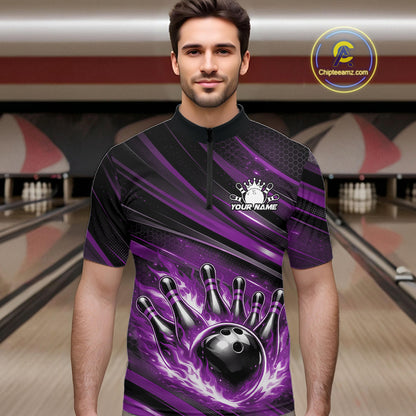 Male model at a bowling lane wearing a black and purple bowling quarter-zip shirt with fiery bowling strike artwork and bold stripe details.
