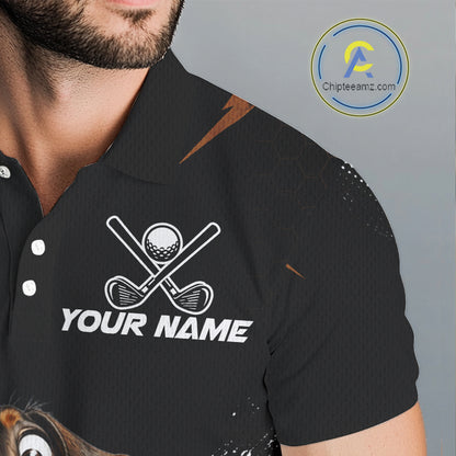 A close-up of a man wearing a black short-sleeve polo shirt with a white golf-themed chest graphic featuring crossed clubs, a golf ball, and the text 'YOUR NAME'.