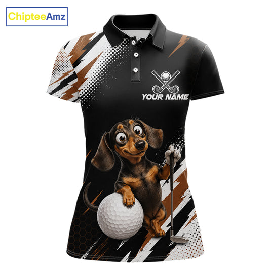 A women's short-sleeve polo shirt with a black base, featuring a cartoon dachshund holding a golf ball and club, with 'YOUR NAME' text and a custom logo area on the chest. The shirt has white, brown, and black graphic patterns on the sleeves and sides.
