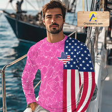 Load image into Gallery viewer, Man wearing a shirt with a pink water pattern and American flag design on a boat.