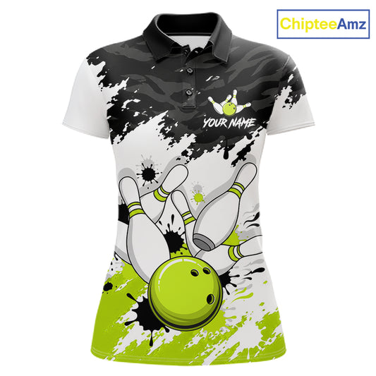 A women's short-sleeve polo shirt with a bowling-themed graphic print. The design features a black and white splatter/camo pattern on the upper chest and shoulders, white bowling pins, and a bright lime green bowling ball at the bottom.