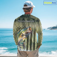 Load image into Gallery viewer, Person wearing a fishing-themed shirt with a large mouth bass graphic and 'Team Name' text, standing by the ocean.