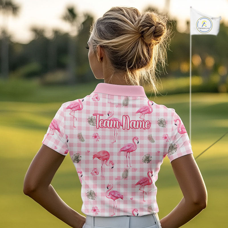 A woman on a golf course seen from behind, wearing a pink and white gingham polo shirt with pink flamingo prints and the text 'Team Name' on the back.