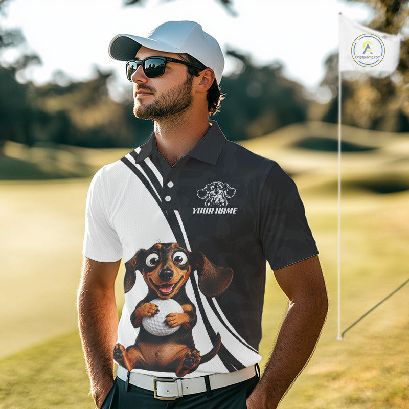 A man wearing a custom golf polo shirt with a split black-and-white design, a cartoon dachshund graphic, and a white cap, standing on a sunny golf course.
