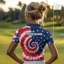 Load image into Gallery viewer, Woman wearing an American flag tie dye womens golf polo shirt and 'Team Name' text on the back, standing on a golf course.