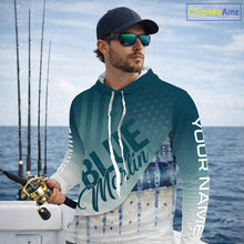 Load image into Gallery viewer, Angler wearing patriotic American Flag Marlin long sleeve hooded fishing shirt on boat
